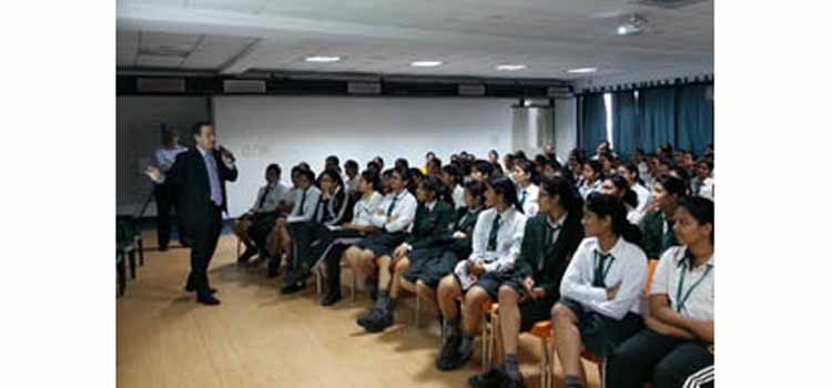Man speaking to a group of students. (Photo Credit: State Department)