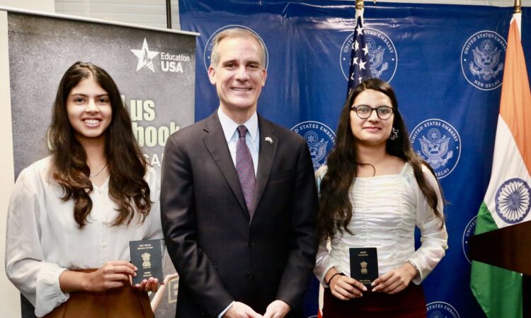 Photo of Ambassador Garcetti with two students who've received their visas.