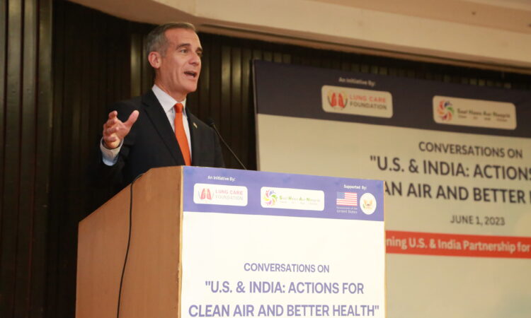 Image of Ambassador Garcetti standing on stage giving his remarks.